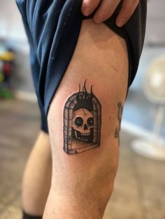 a man with a skull tattoo on his leg