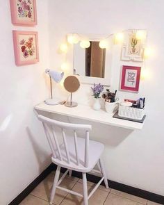 a white chair sitting next to a desk with a mirror and lights on top of it