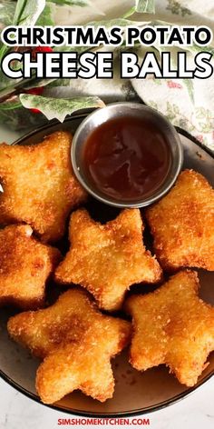 christmas potato cheese balls on a plate with ketchup and dipping sauce in the middle