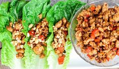 lettuce wraps filled with meat and vegetables on top of a white platter