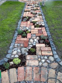 a garden path made out of bricks and stones