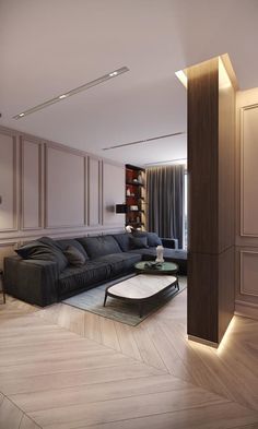 a living room filled with furniture next to a tall book shelf on top of a hard wood floor