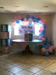 a baby shower is set up with balloons, blocks and a welcome sign for the baby