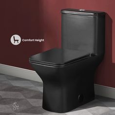 a black toilet sitting in a bathroom next to a red wall with the words comfort height written on it