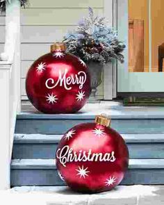 two red christmas ornaments sitting on the steps