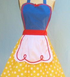 a yellow and blue dress with white polka dots on the bottom, red trim around the waist