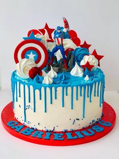 the cake is decorated with captain america and red white and blue icing on it