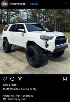 a white truck parked on top of a parking lot