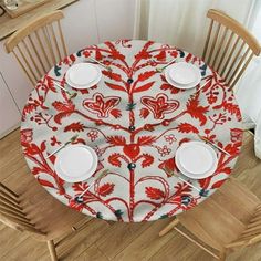 the table is set with plates and place settings for four people to enjoy dinner together