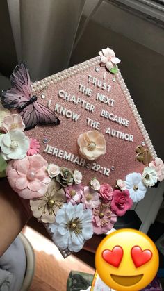 a pink graduation cap decorated with flowers and butterflies