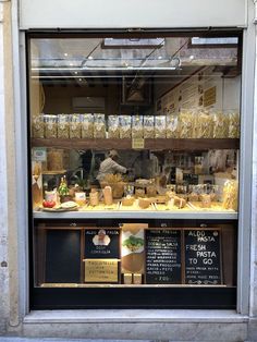 a store front window filled with lots of food