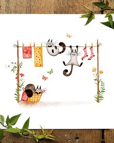 two cats hanging out on clothes line with green leaves