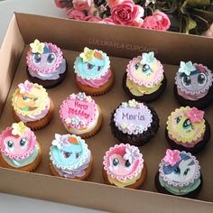 a box filled with lots of cupcakes covered in frosting