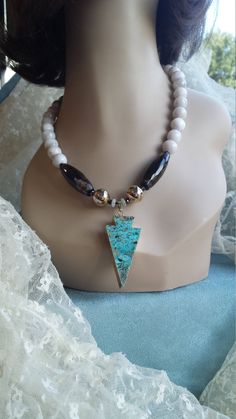 "A beautiful faceted white (multiple of white colors) 12mm agate. The tubed black faceted polished onyx is 35mm wide by 14mm. The pendant is a flat polished turquoise jasper with a gold border. The lenght of this gorgeous necklace is 19\" long please plus another 2 1/4\" for the pendant. I used gold and siver accents. A great look for that special outfit." White Amazonite Jewelry With Natural Stones, White Amazonite For Jewelry Making, Unique Amazonite Jewelry With Round Beads, White Beaded Amazonite Jewelry, Unique Arrowhead Jewelry With Natural Stones, Howlite Gemstone Beads Jewelry For Gifts, Howlite Gemstone Beads Jewelry As A Gift, Unique Arrowhead Natural Stone Jewelry, Unique Faceted White Jewelry