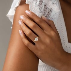 a close up of a person's hand with a ring on her left arm