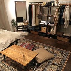 a living room filled with furniture and a large rug on top of a wooden floor