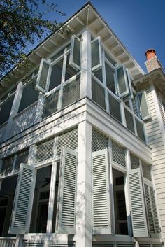 a large white house with many windows and shutters