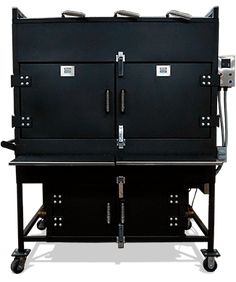 a large black oven sitting on top of a cart