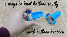 someone is holding two blue balloon holders on a table with the words 3 ways to knot balloon easily