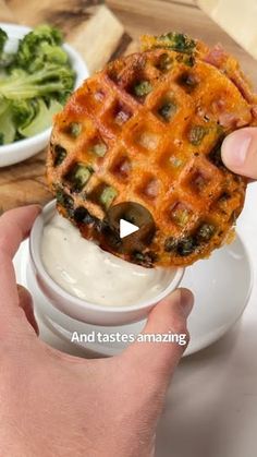 a person is dipping something into a waffle on top of some broccoli