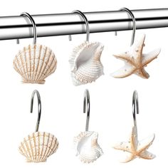 six seashells are hanging on a metal bar and hangers in the shape of starfishs