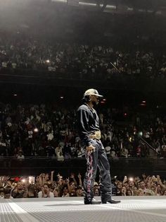 a man standing on top of a stage in front of a crowd