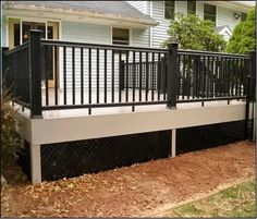 a black and white deck railing next to a house