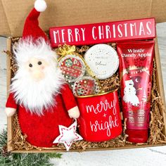 a christmas gift box with a santa claus doll, body lotion and hand cream