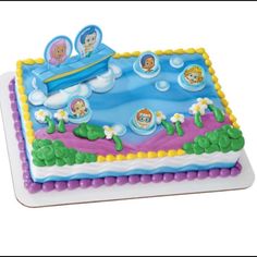 a birthday cake decorated with cartoon characters on it