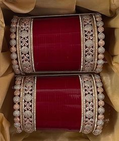 two red and gold bracelets in a box