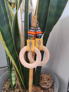 These colorful earrings are bright bold and beautiful. Blue and orange ghanian powdered glass beads play off of a raw wooden hoop, yellow leather and black and white bone beads. They also have grounding hematite above and below. A dainty silver tribal silver spear. dangles from the center. Perfect for a street festival or just for bringing the funk to a casual day! Handmade Yellow Circular Jewelry, Adjustable Festival Earrings With Wooden Beads, Festival Earrings With Wooden Beads, Adjustable Hoop Jewelry With Wooden Beads, Handmade Bold Round Beads Jewelry, Bold Handmade Round Beads Jewelry, Handmade Bold Round Bead Jewelry, Bohemian Small Hoop Orange Jewelry, Bold Handmade Jewelry With Round Beads