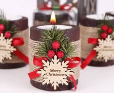 three candles with christmas decorations on them