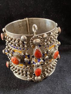 A beautiful authentic antique bracelet of the Beni Yenni, Kabylia, Algeria. Perfect condition. High grade silver, blue and yellow enamel and mediterranean red coral. The bracelet has a weight of 202 grams! Diameter : 6 cm Height : 6,5 cm Antique Metal Bracelets For Festivals, Vintage Bracelets For Ceremonial Festivals, Unique Ceremonial Jewelry With Intricate Design, Vintage Festival Bracelet Jewelry, Vintage Festival Jewelry Bracelet, Collectible Intricate Design Jewelry Bracelet, Antique Heavy Bracelet Jewelry, Antique Bangle For Festival, Antique Bangle Jewelry For Festivals