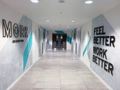 an empty hallway with blue and white letters on the walls