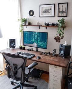 a desk with a computer and speakers on it