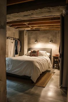 a bed sitting in the middle of a bedroom next to a doorway with clothes hanging on it