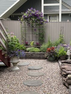 an outdoor garden with stepping stones and flowers