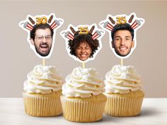 three cupcakes with the faces of two men and one woman