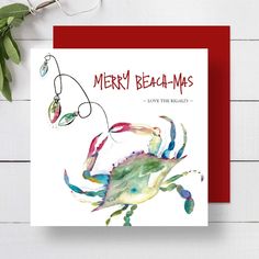 a christmas card with a watercolor painting of a crab on it's back