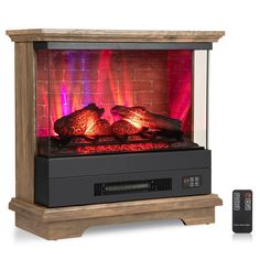 an electric fireplace with red flames and remotes next to it on a white background