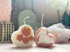 two heart shaped soaps with roses on them