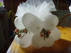 a vase that has flowers in it sitting on a table with plastic bags over the top