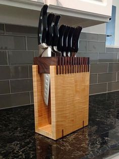 a wooden block with knives in it sitting on a counter