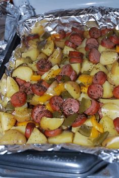 cooked sausage and potato bake in foil with the words smoked sausage and potato bake