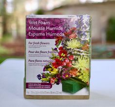 a book with flowers on it sitting on a table