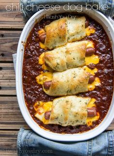 baked chili cheese dog bake in a white casserole dish on a wooden table