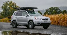 a silver subarunt parked on the side of a road