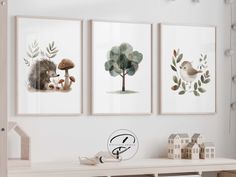 three paintings on the wall in a child's room, one with a hedgehog and bird