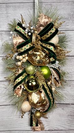 a christmas wreath hanging on the side of a wooden wall with ornaments and decorations around it