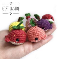 small crocheted toys in the palm of someone's hand that is holding them